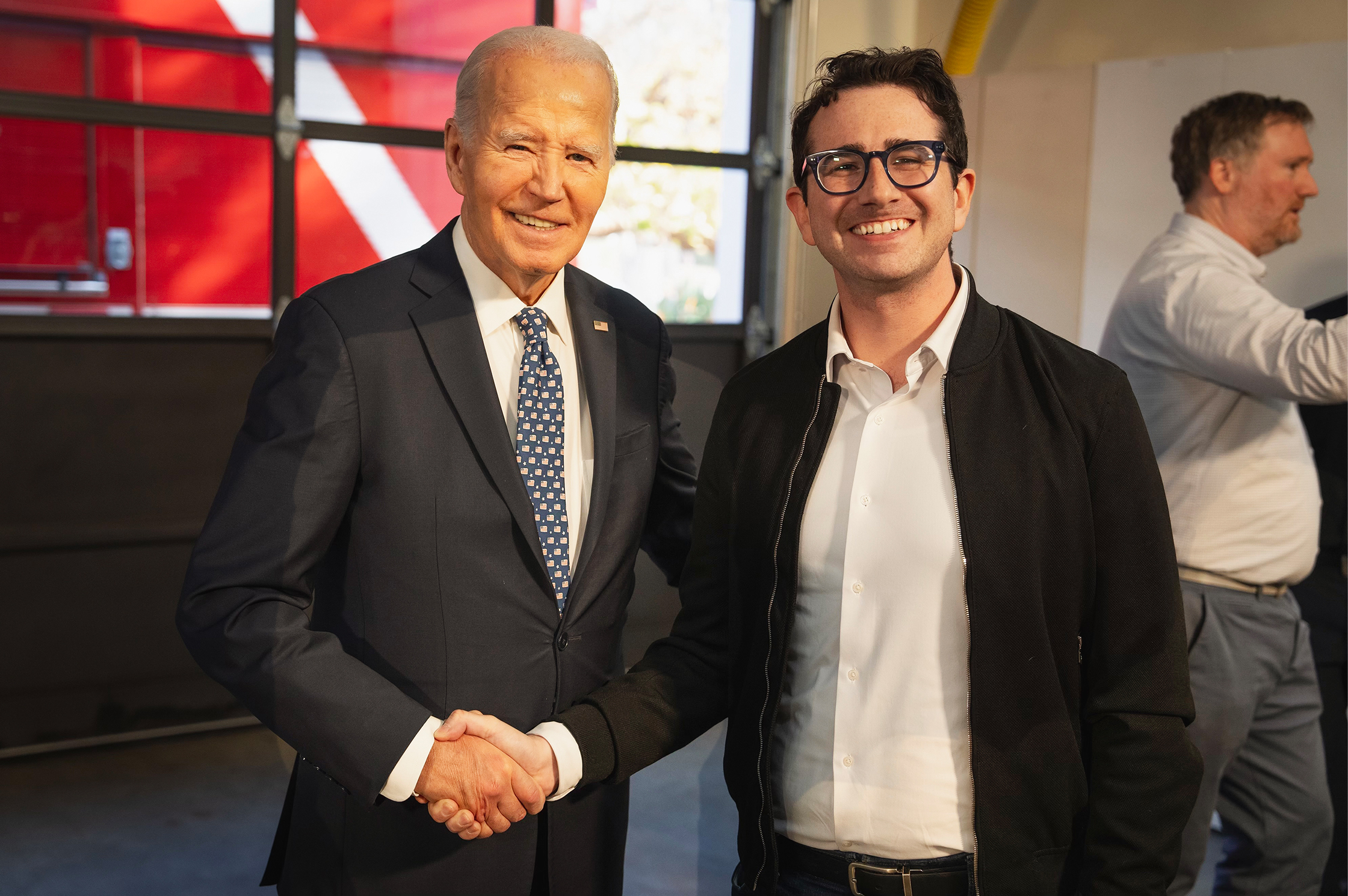 Izzy Gardon standing with former President, Joe Biden shaking hands