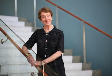 A portrait of Anne Farrell on the stairs in Lemieux Library