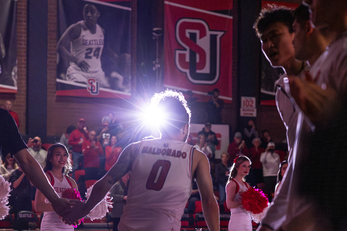 A photo of a basketball player being introduced onto the court in the beginning of the game