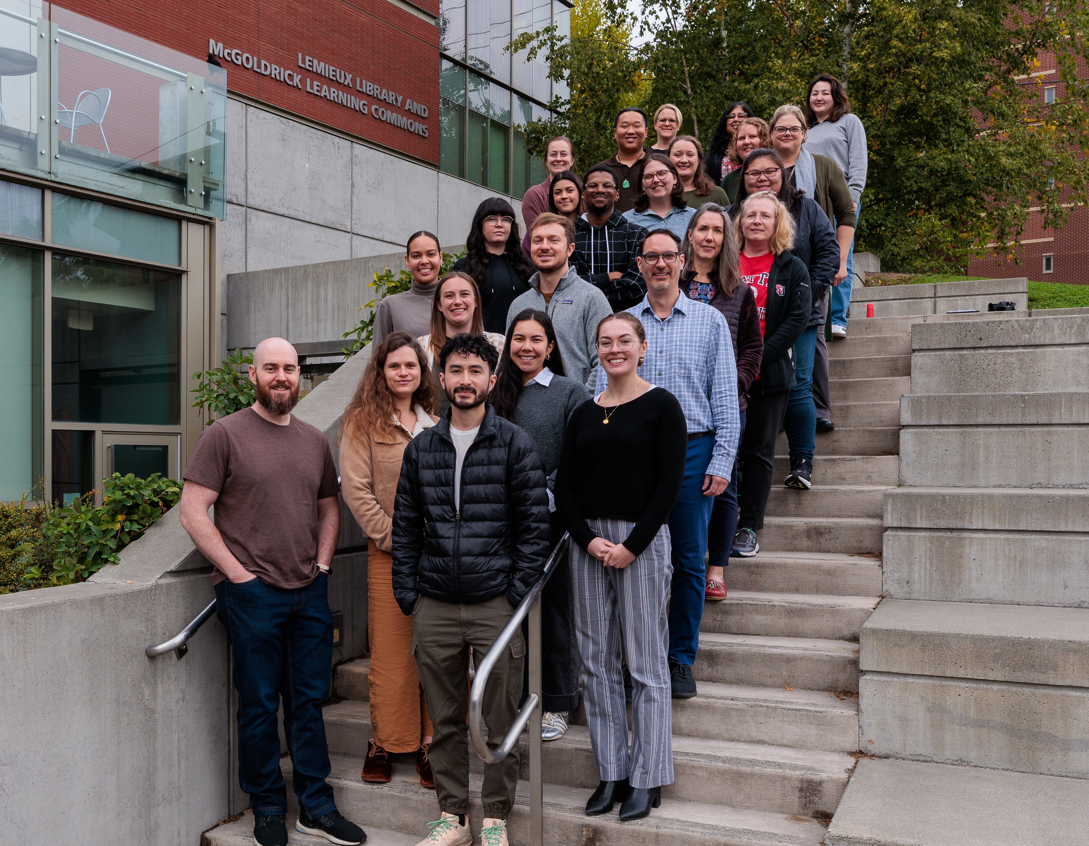 Photo of academic advising staff on front steps of Lemieux Library at Seattle University campus.