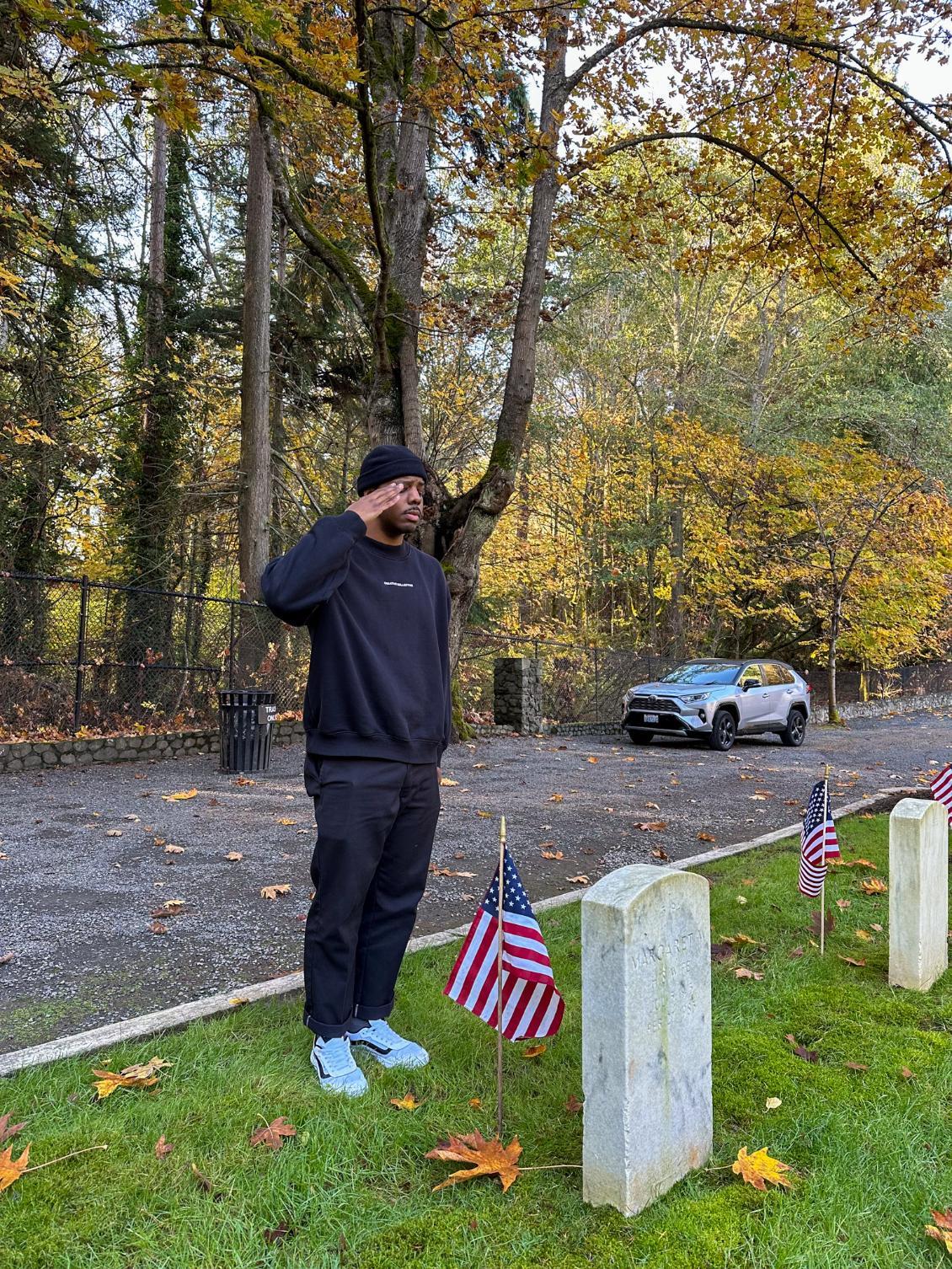 Cadet saluting flag grave