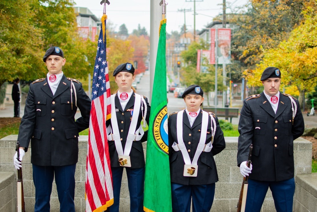 Cadets in dress uniforms with flags