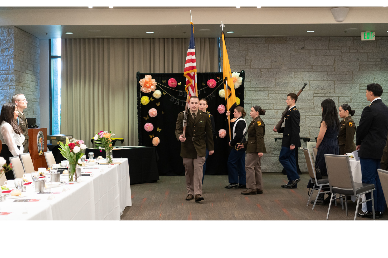 Cadets in uniform with flags