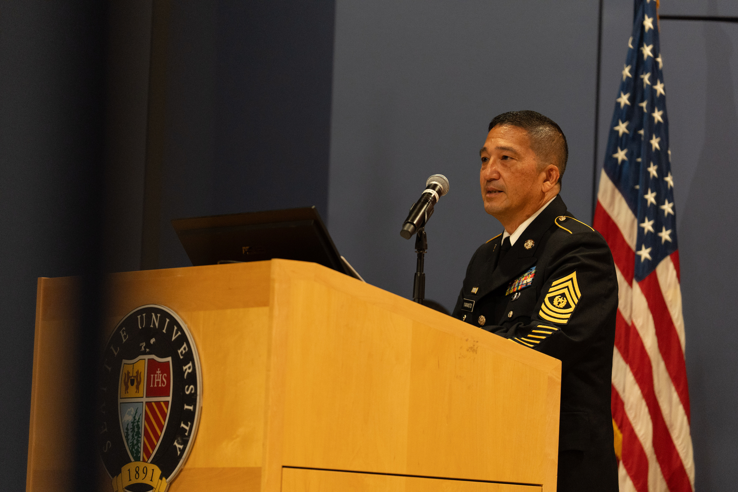 Man in uniform speaking at podium