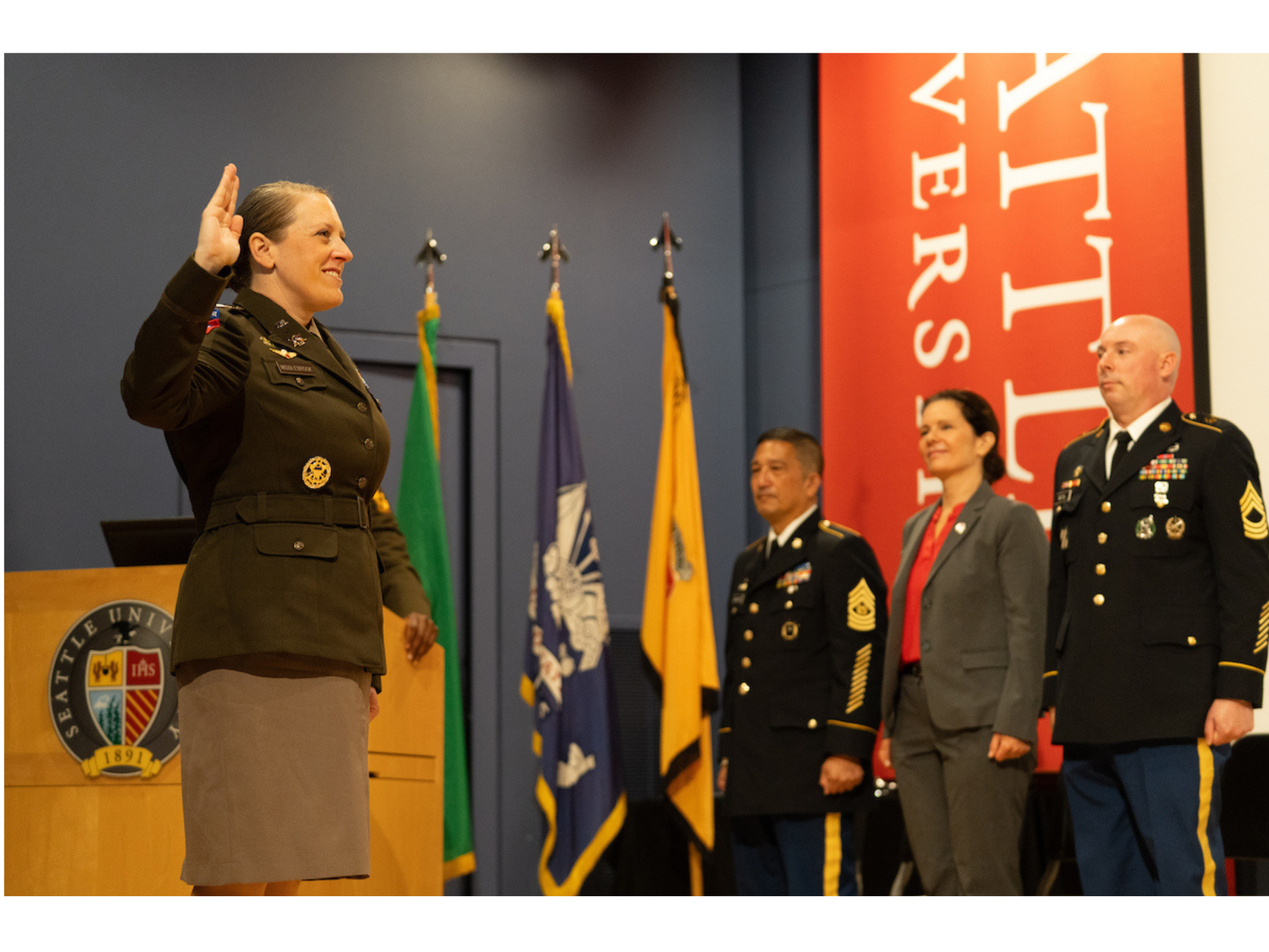 Female officer standing in front of 3 officials