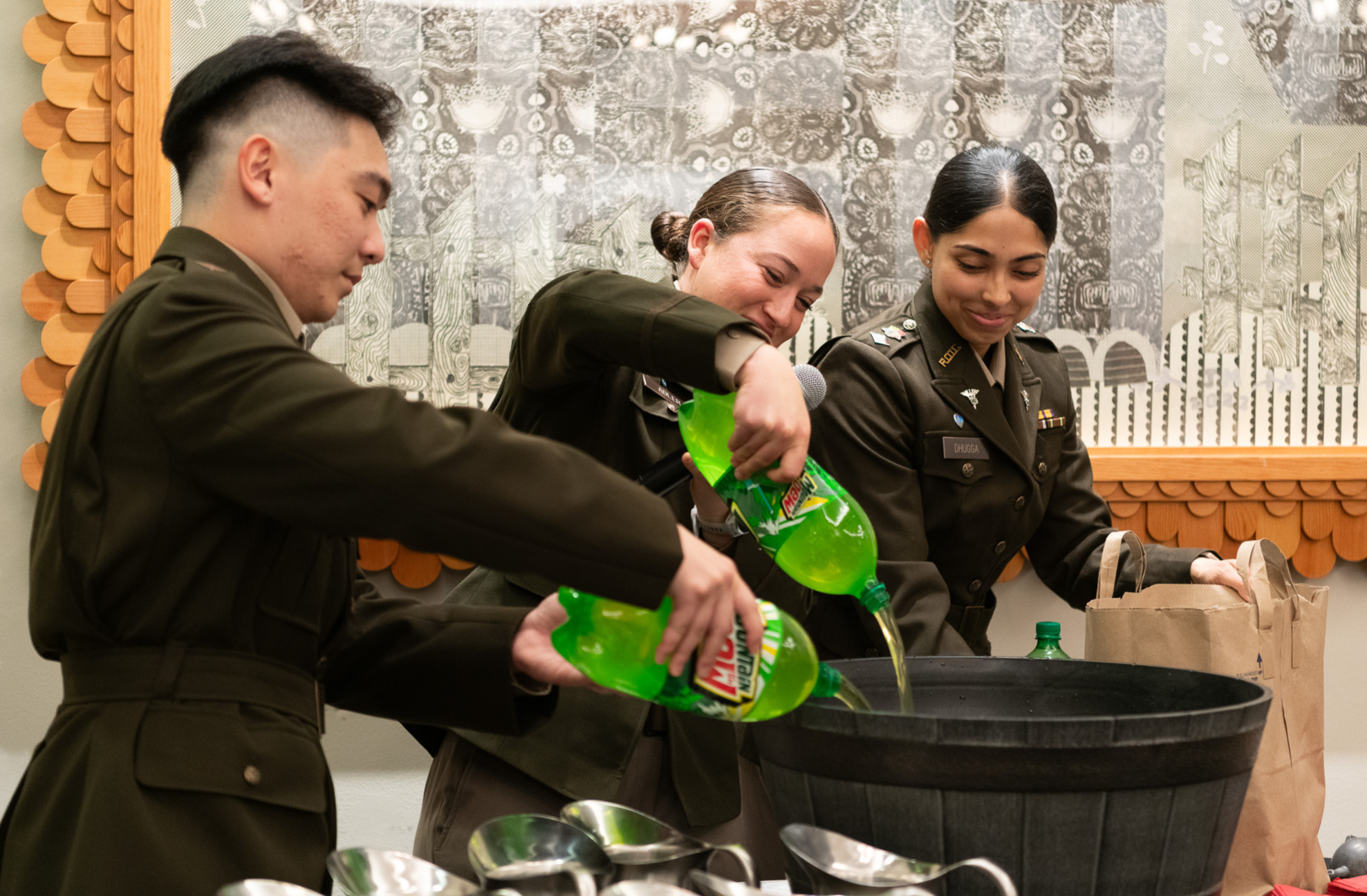 Cadets pouring soda into large container