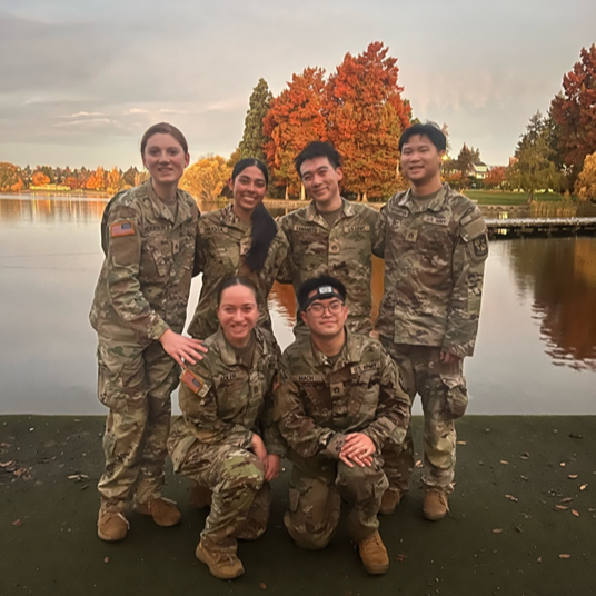Seven cadets at lake in army green