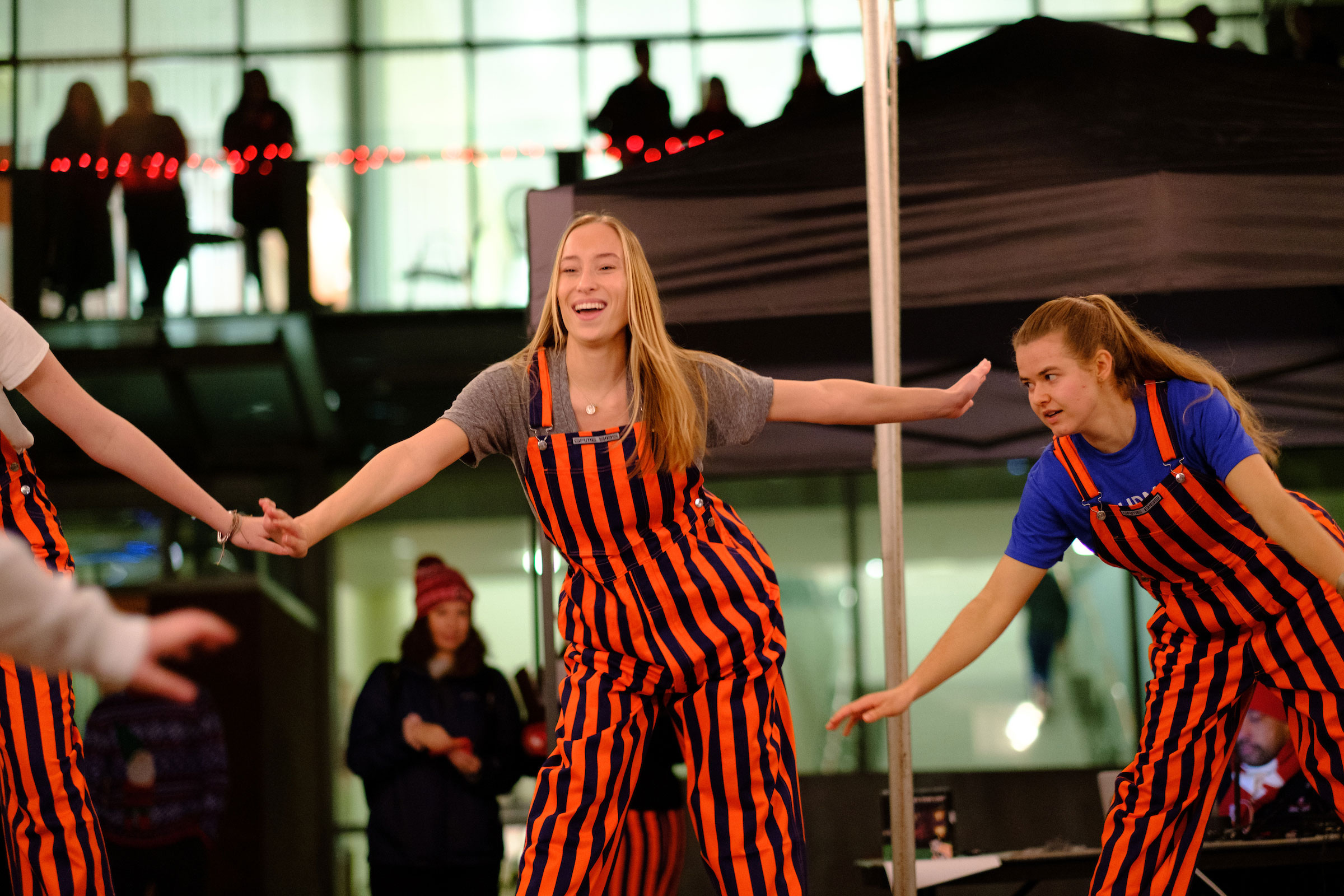 students in red striped overall costumes perform together