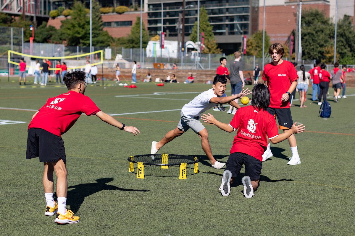 Students participate in a game on the field.  