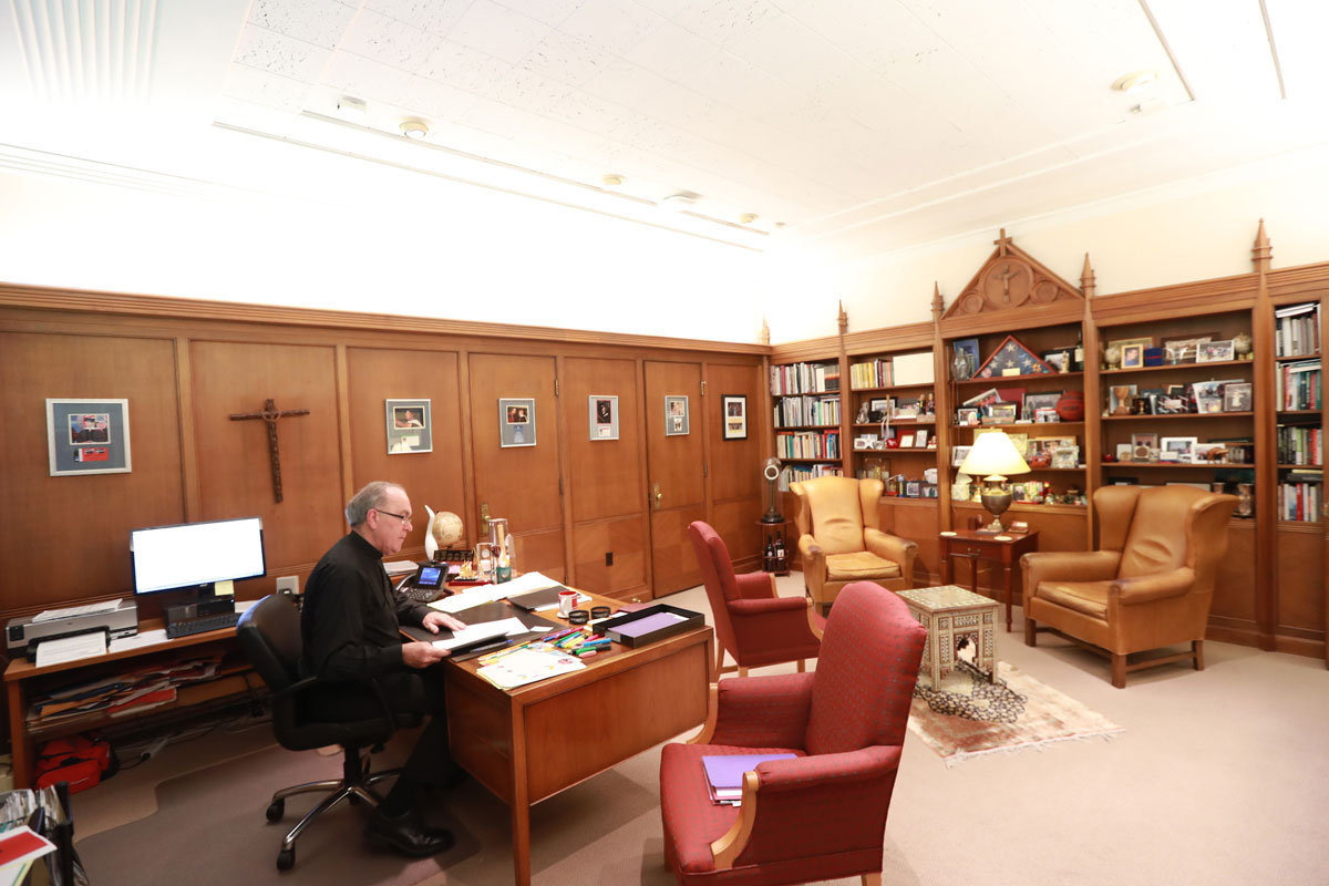 Father Steve sits at his desk in his office