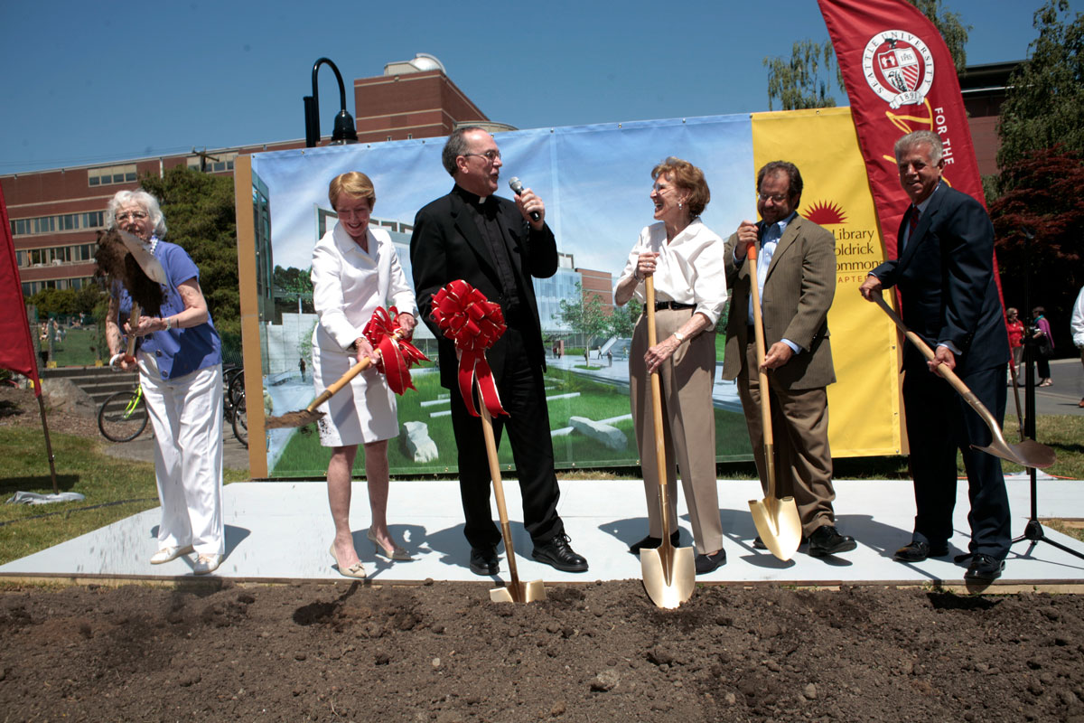 President Sundborg joins other members of SU holding shovels and breaking ground on the library renovation