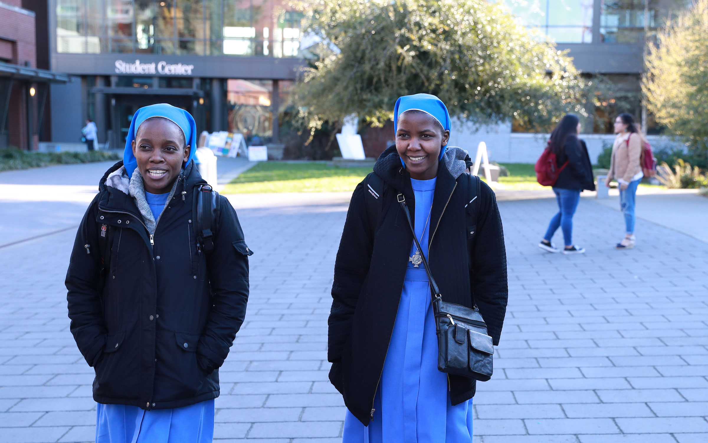 Sister Nakitende and Sister Namutebi walking along the SU lower mall