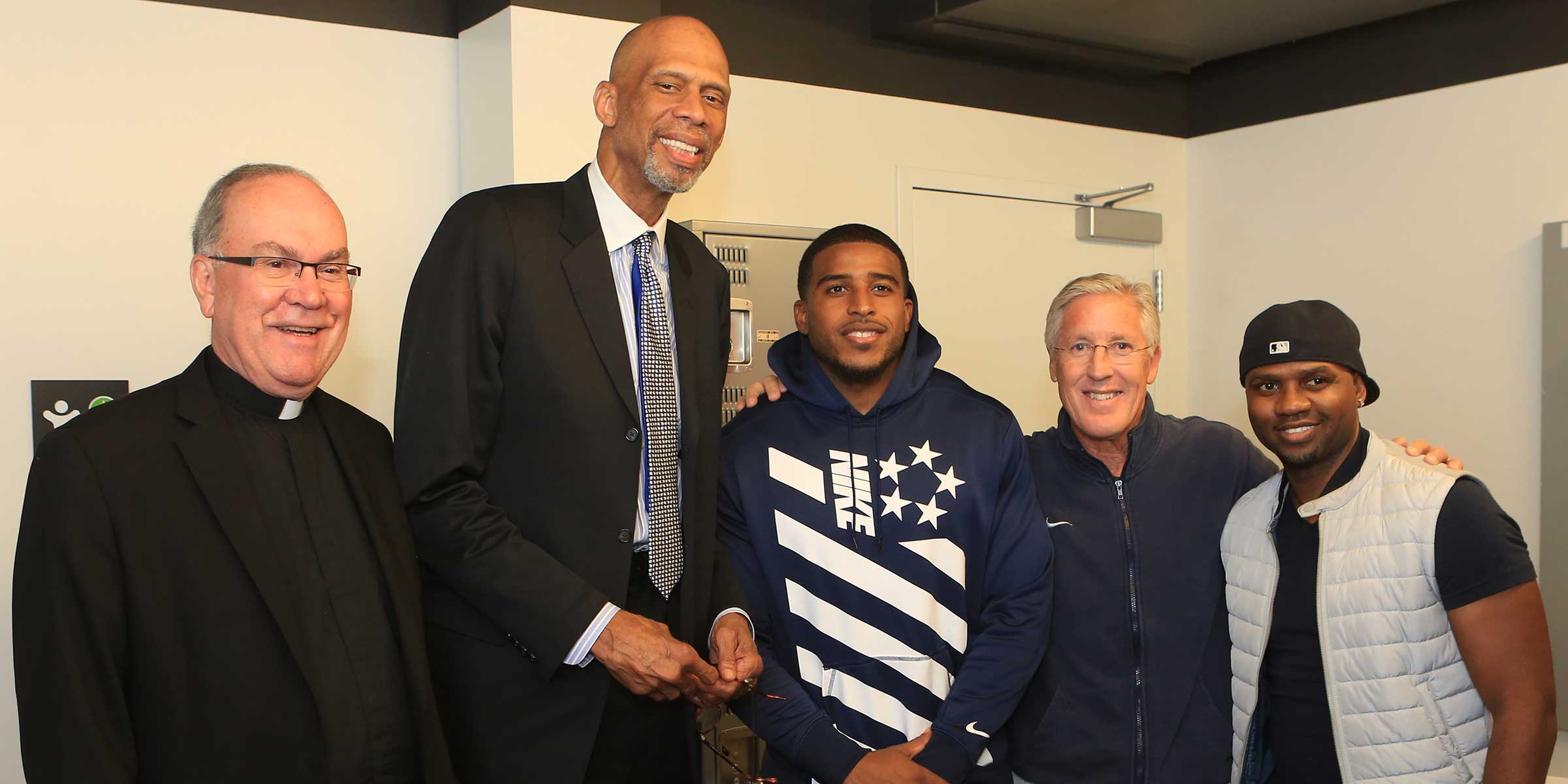 Father Steve pictured with Kareem Abdul-Jabbar, Bobby Wagner, Pete Carroll, and one other unidentified person on September 9, 2016 at the Seattle Town Hall.