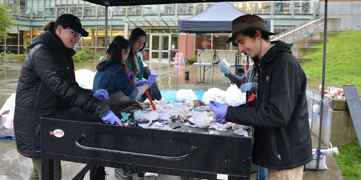 SU student and faculty volunteers hand-sorting compostable waste