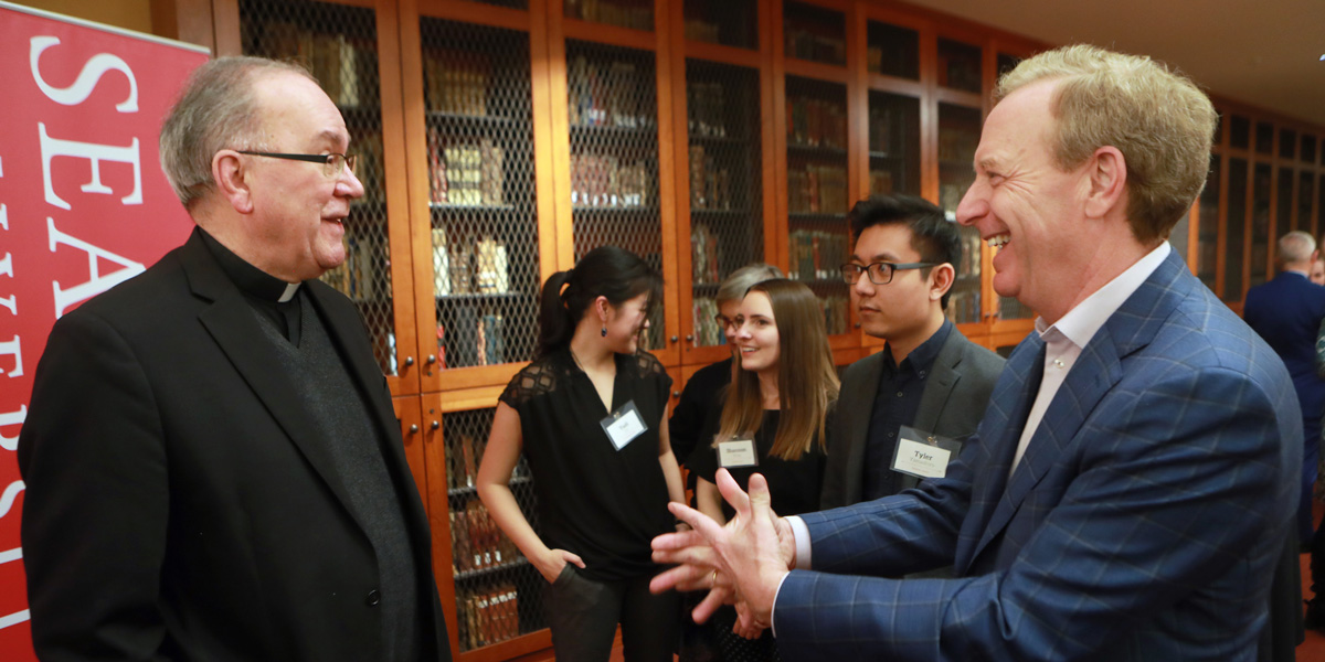 Brad Smith, President and Chief Legal Officer of Microsoft, talks with Seattle University President Stephen Sundborg and students
