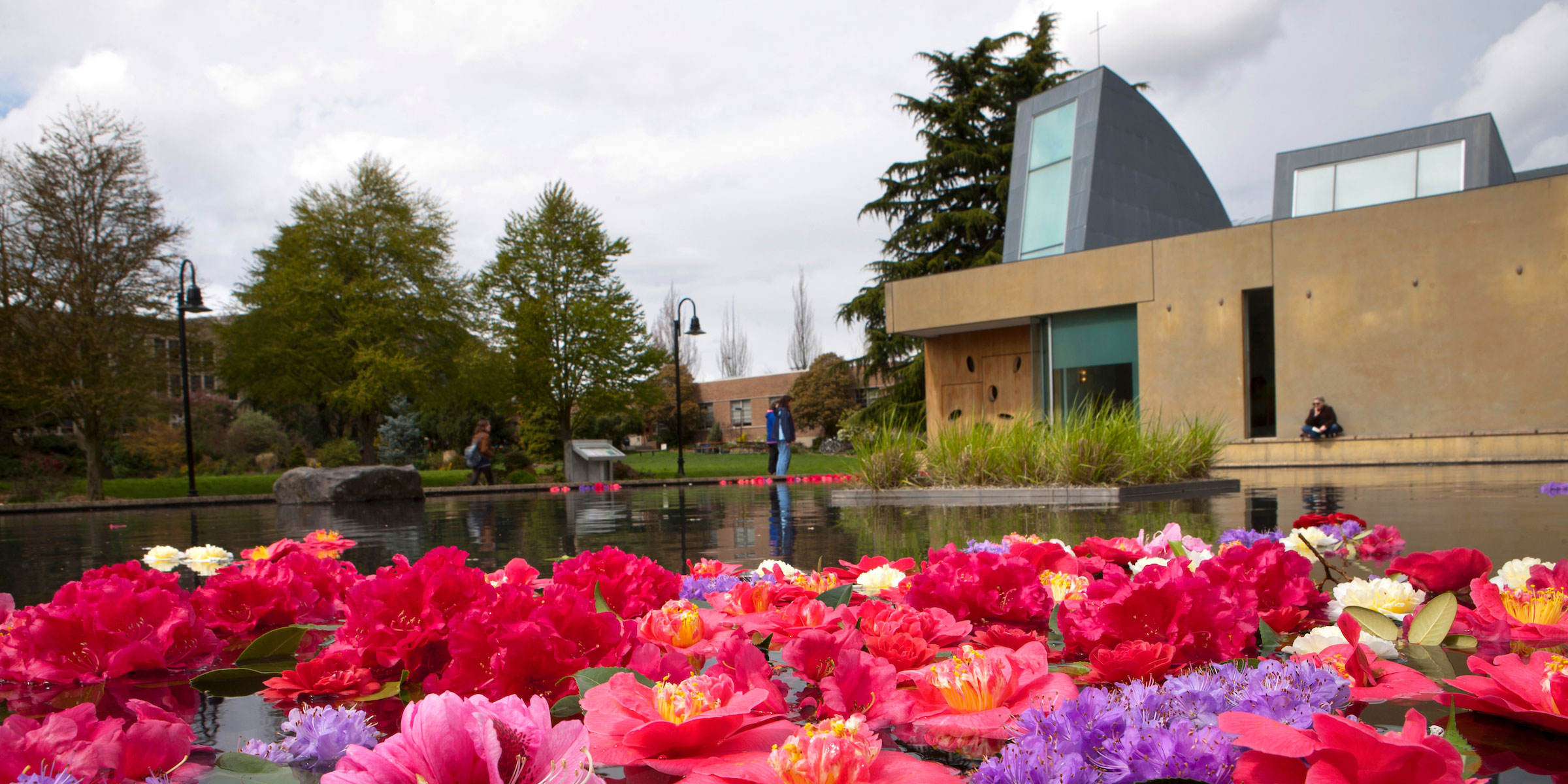 flowers float in the reflection pool in front of SU's iconic St. Ignatius Chapel
