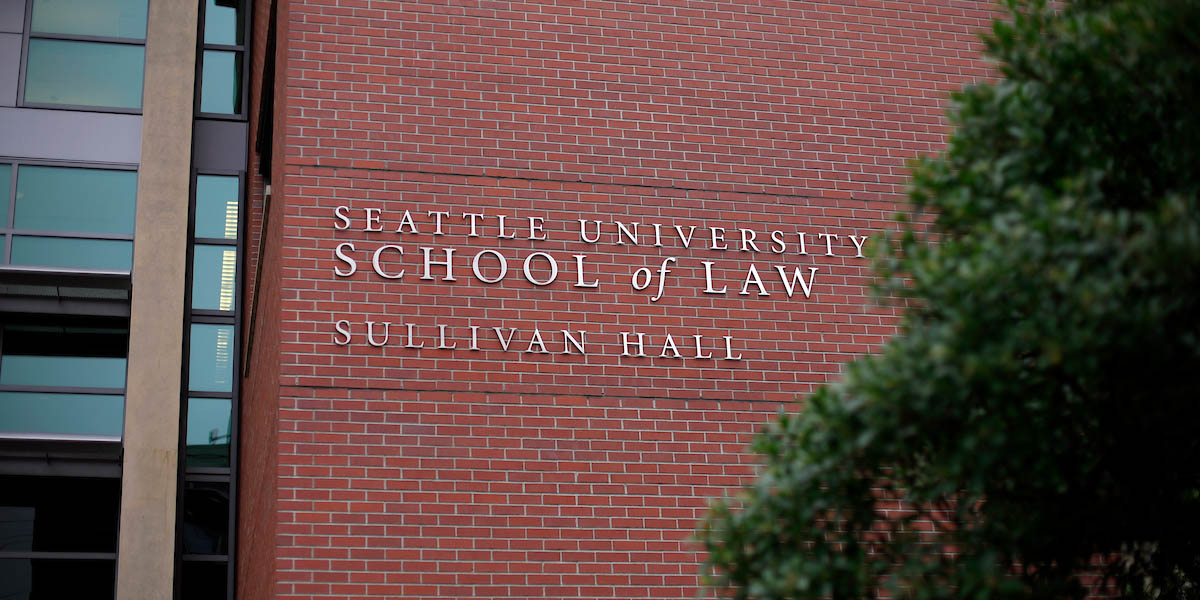 Exterior of brick building with signage that reads: Seattle University School of Law. Underneath text reads: Sullivan Hall.