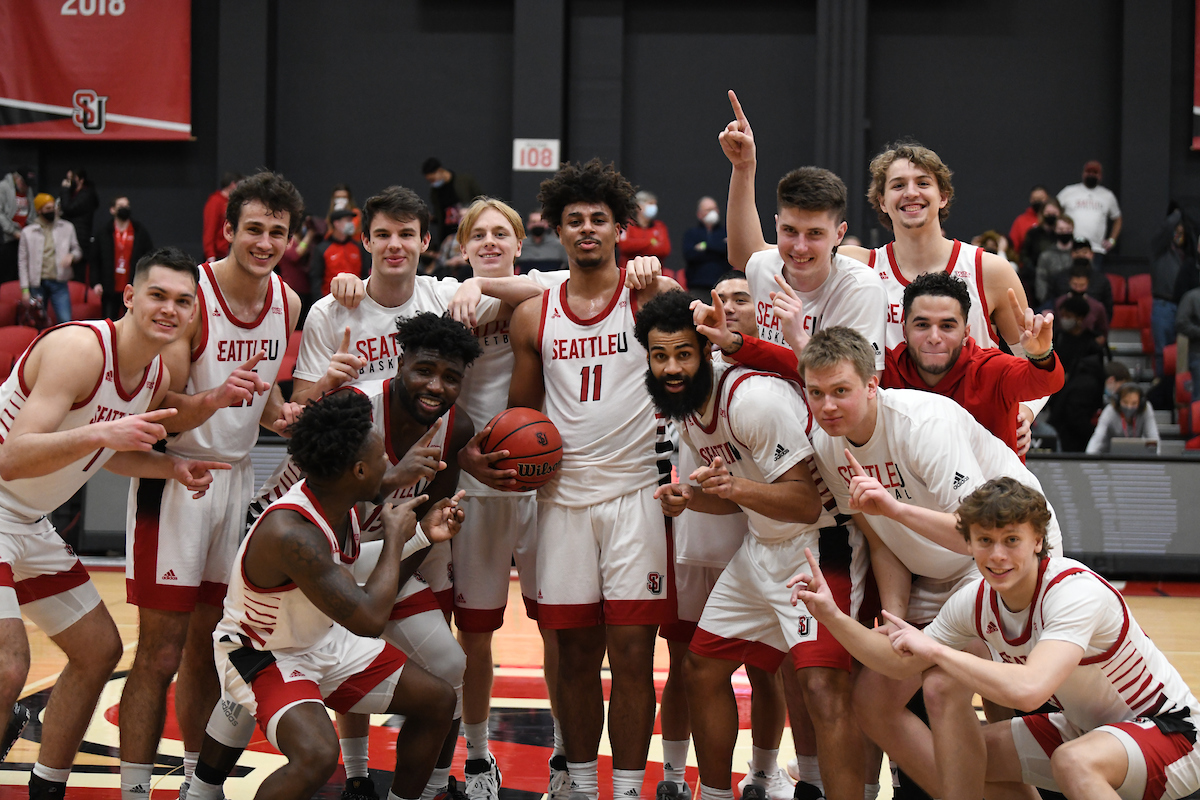 Men's basketball celebrate after the team's latest win.