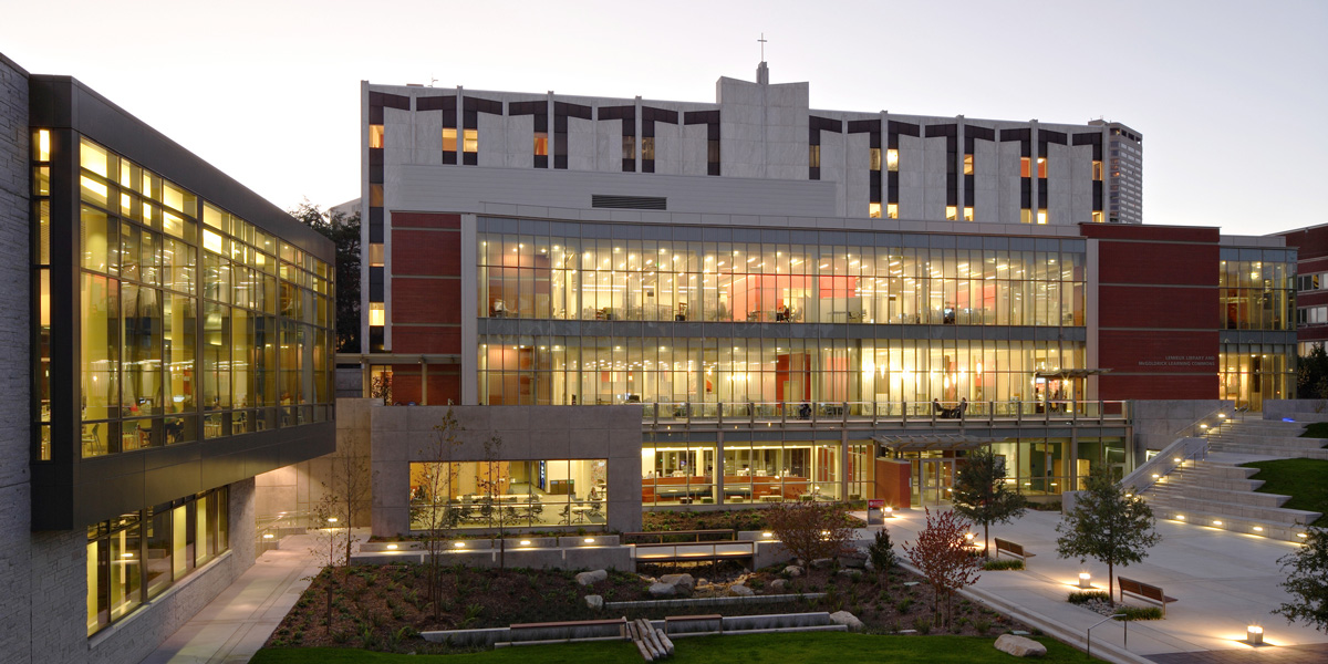Exterior of Lemieux Library with lights on in the evening