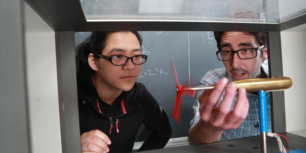 a professor and engineering student working on a project