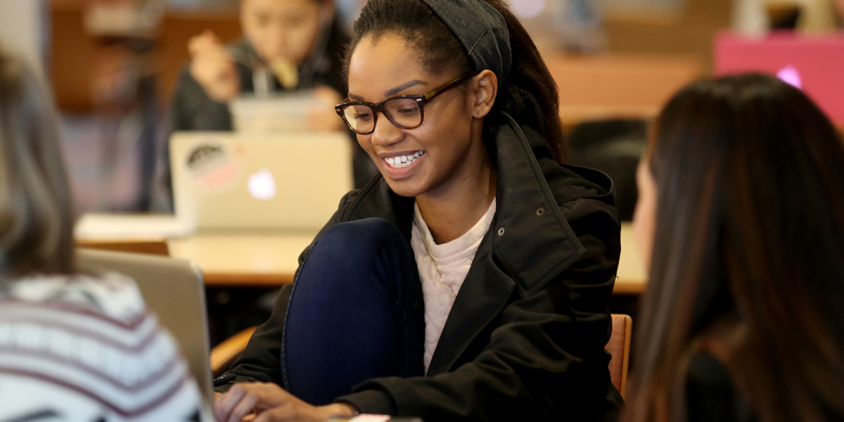 SU students working on their laptops in the library