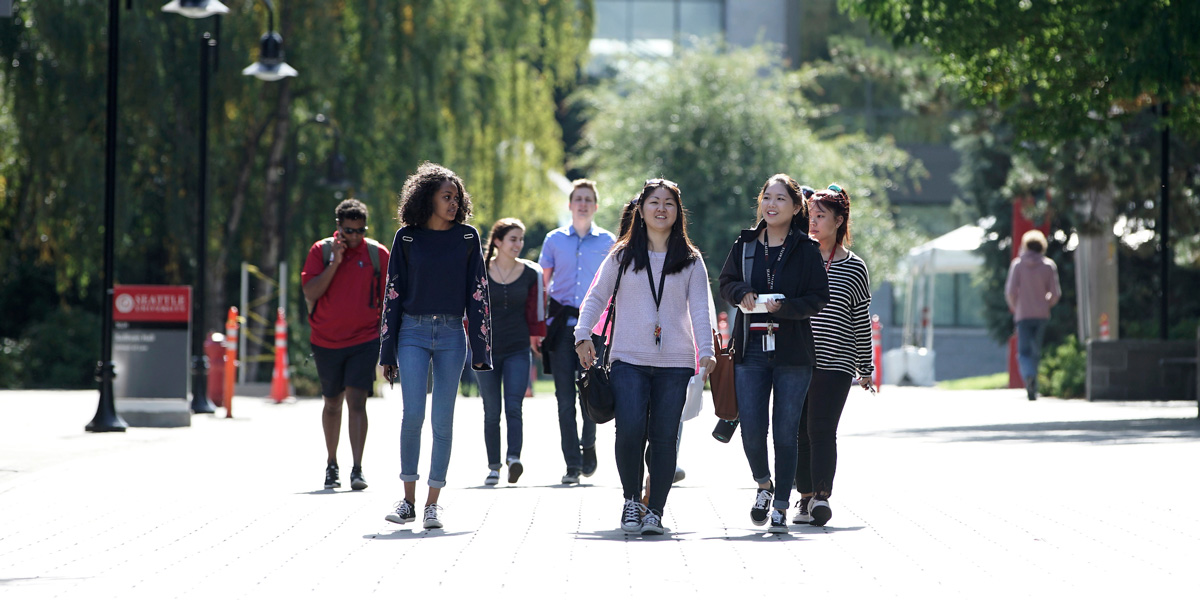Students talking and walking through campus