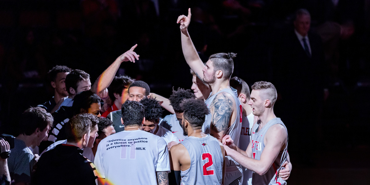 Seattle U Men's Basketball Team in a group huddle