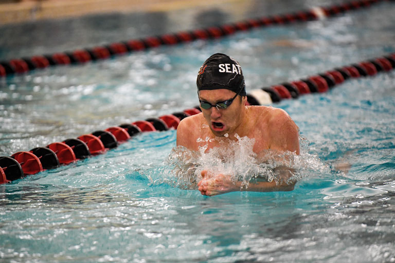   Jack Neton, ’22, swimming the breaststroke.